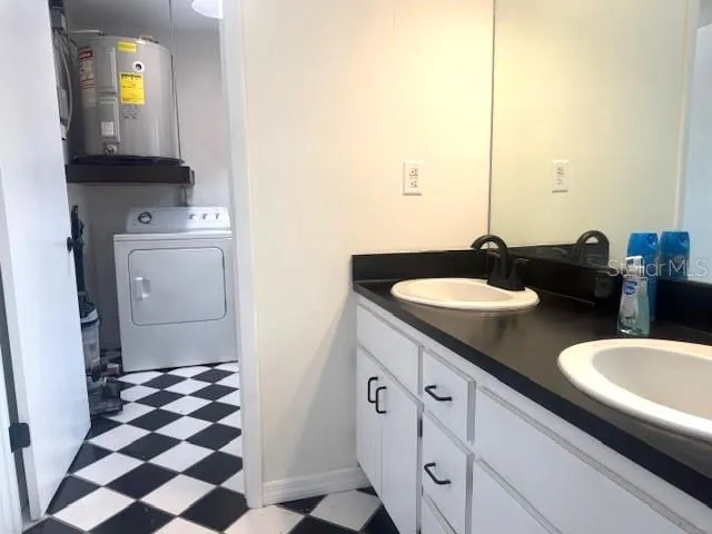 a bathroom with a sink a toilet and a mirror