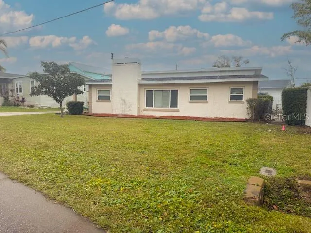 a view of a house with yard and sitting area