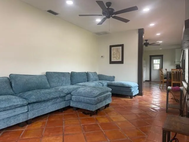 a living room with furniture and a glass door