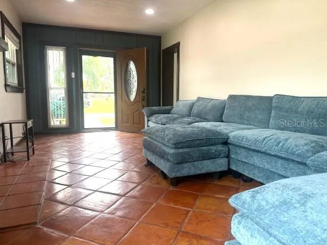 a living room with furniture and large windows