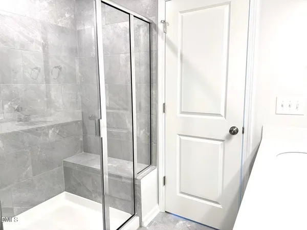 a bathroom with a glass shower door