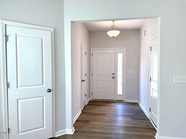 a view of a hallway with wooden floor