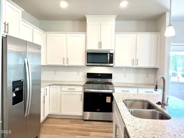 a kitchen with a sink stove and refrigerator