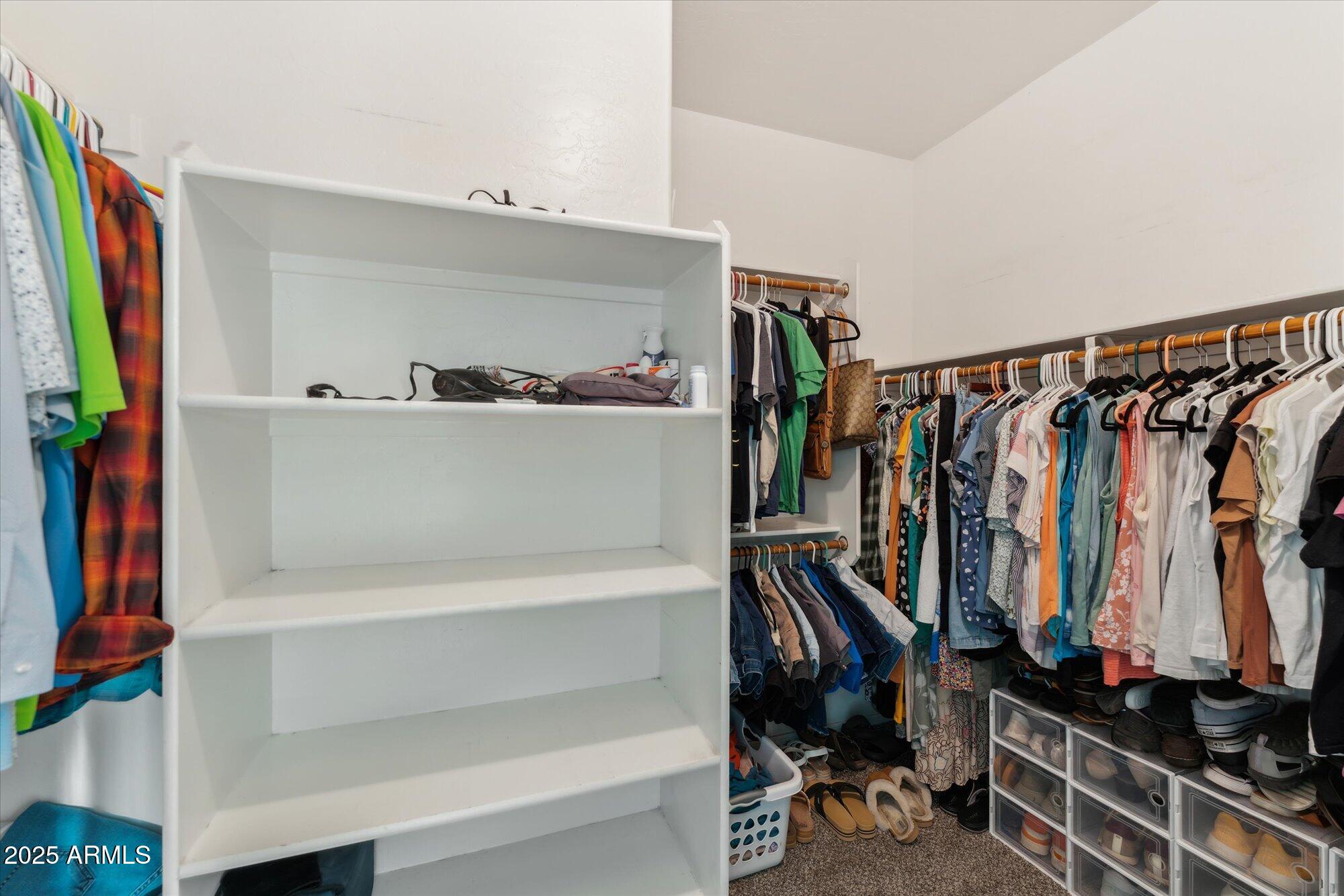 1924 South Rome Street Gilbert, AZ 85295 - Photo 36 of 60 a view of walk in closet with clothes and shoes