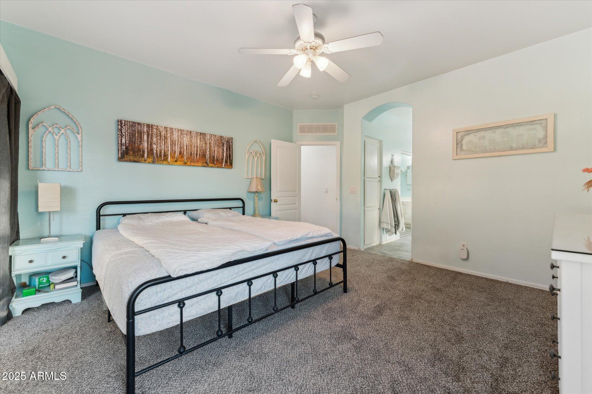 1924 South Rome Street Gilbert, AZ 85295 - Photo 39 of 60 a spacious bedroom with a bed and a chandelier