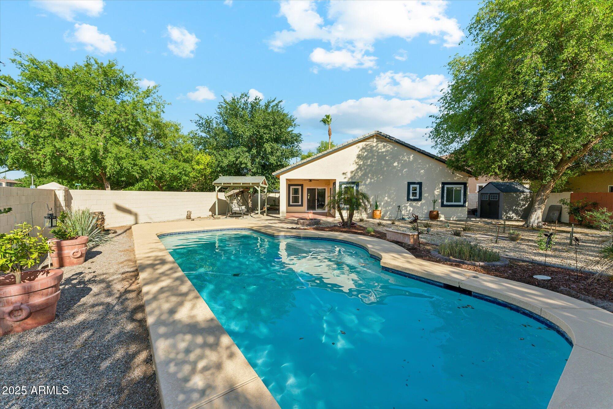 1924 South Rome Street Gilbert, AZ 85295 - Photo 6 of 60 a front view of house with yard and trees in the background