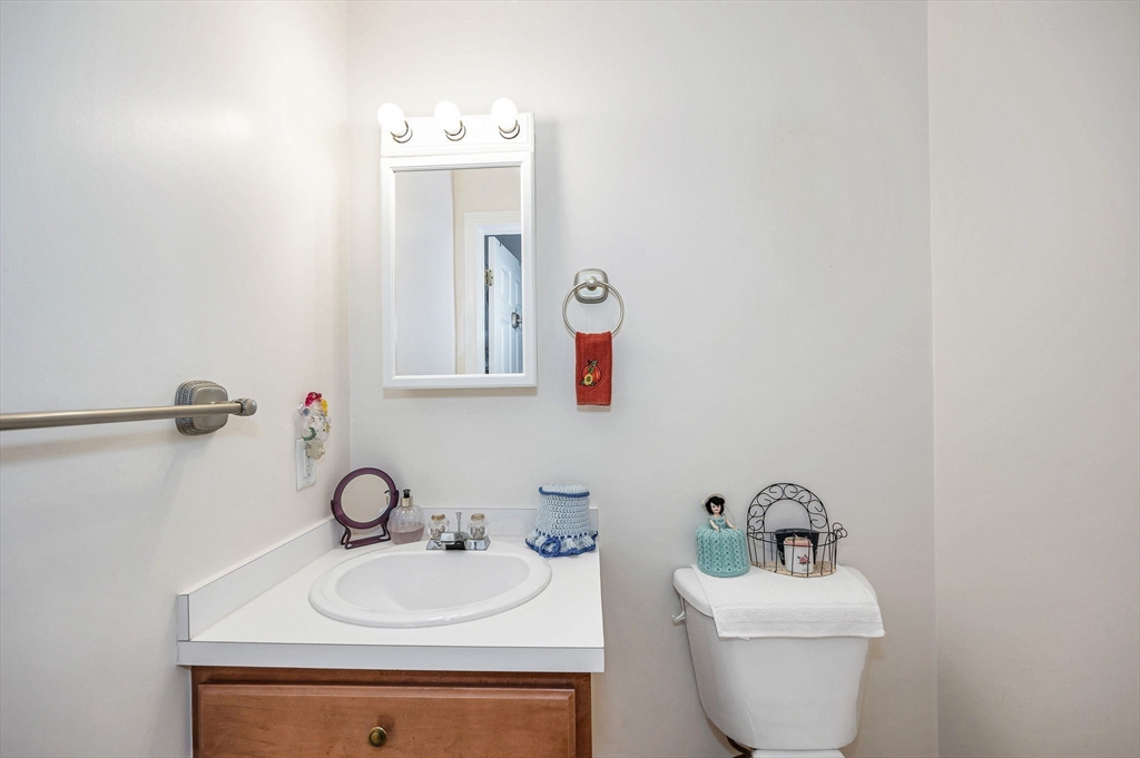 39 Broadway, Unit 305 Malden, MA 02148 - Photo 15 of 36 a bathroom with a toilet sink and mirror