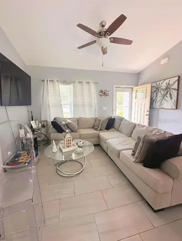 a living room with furniture and a large window