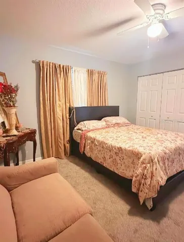 a bedroom with a bed and a large window