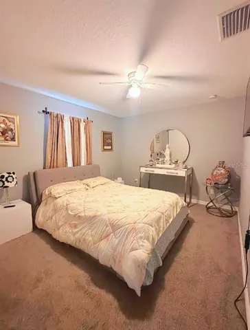 a bedroom with bed and window
