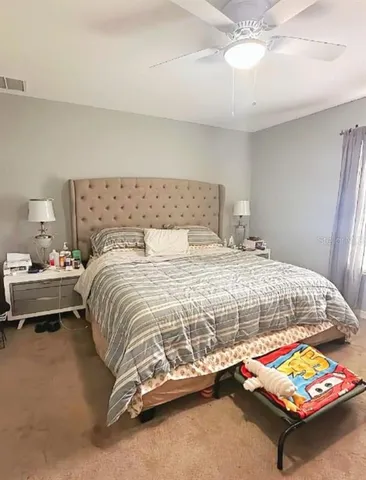 a bedroom with a bed and a couch