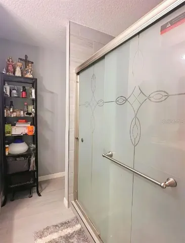 a bathroom with a shower and a sink