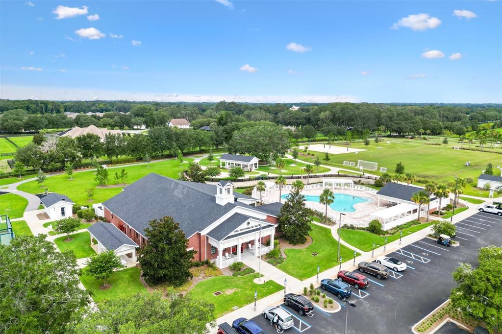 7351 Southeast 169th Cote Loop The Villages, FL 32162 - Photo 29 of 32 an aerial view of a house with a garden and swimming pool