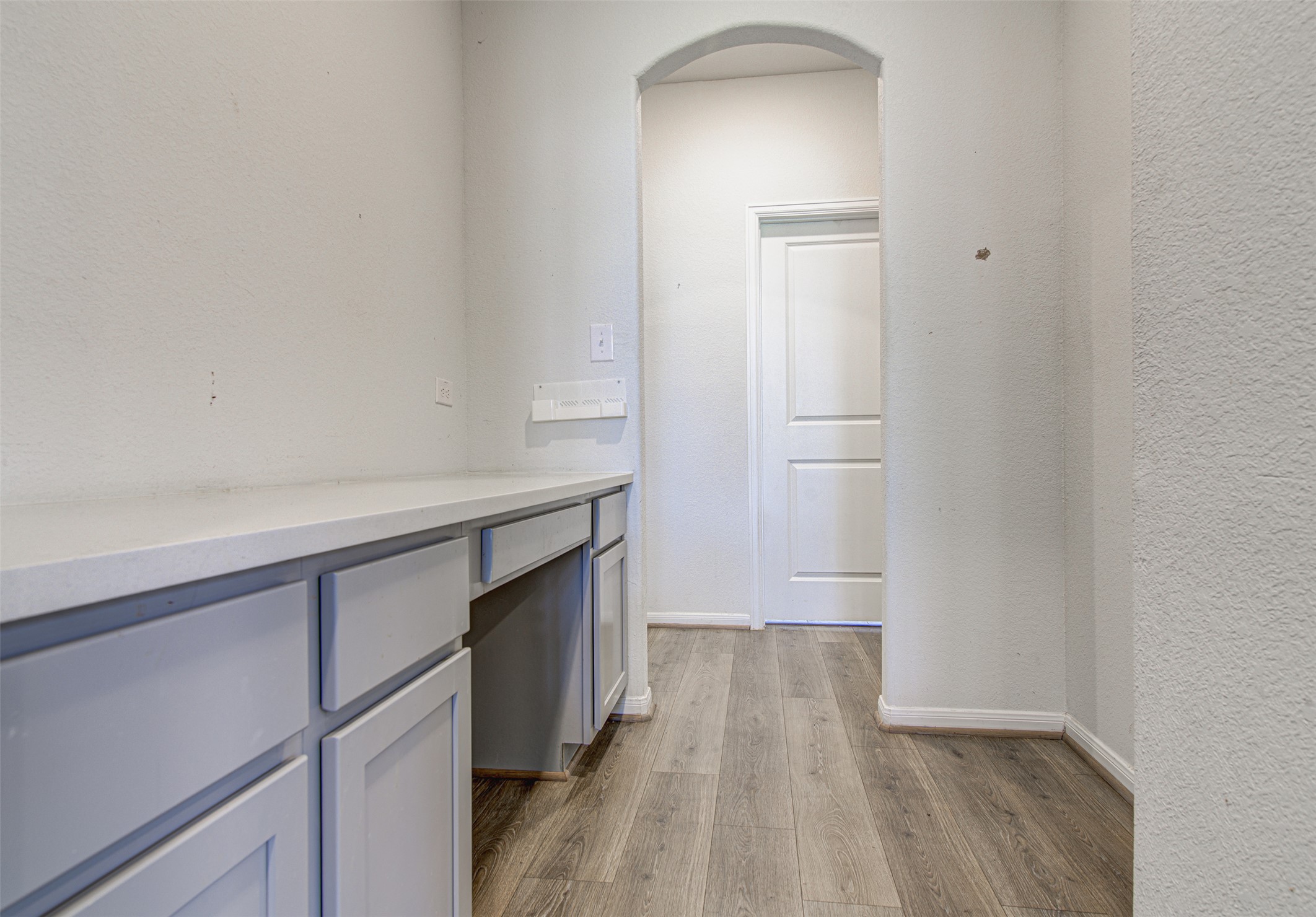 774 Cherrystone Loop Buda, TX 78610 - Photo 10 of 38 A built-in desk with ample storage complements the rich wood flooring in this functional space.