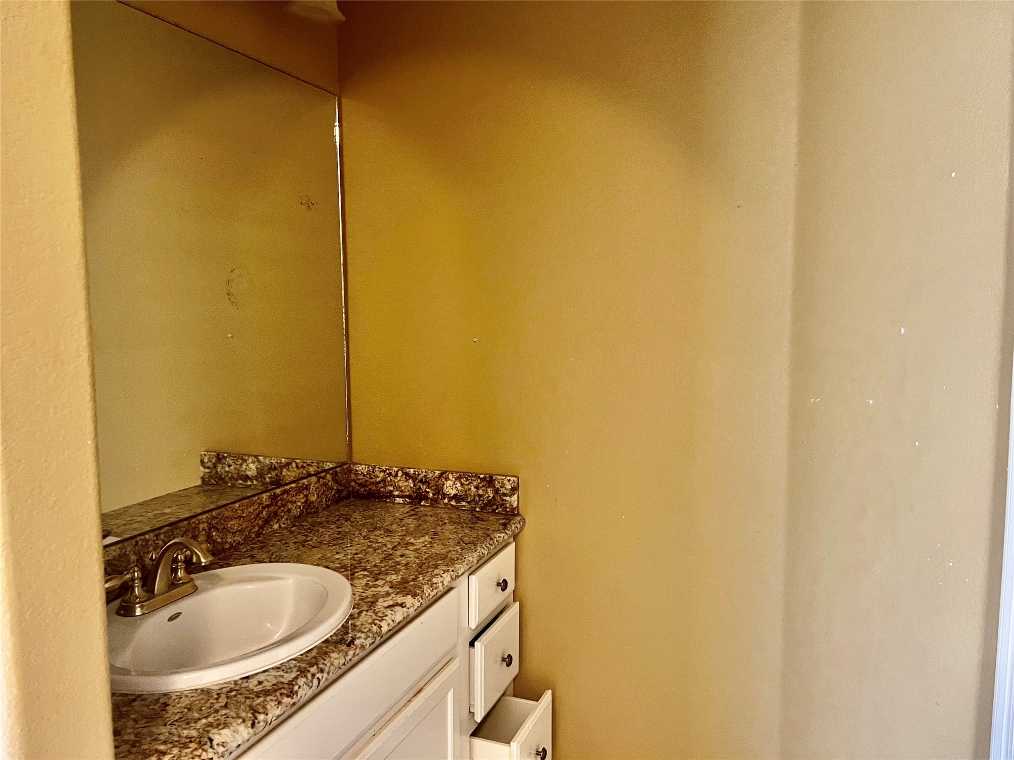 3301 Roya Court Port Arthur, TX 77642 - Photo 29 of 40 a bathroom with a granite countertop sink and a mirror