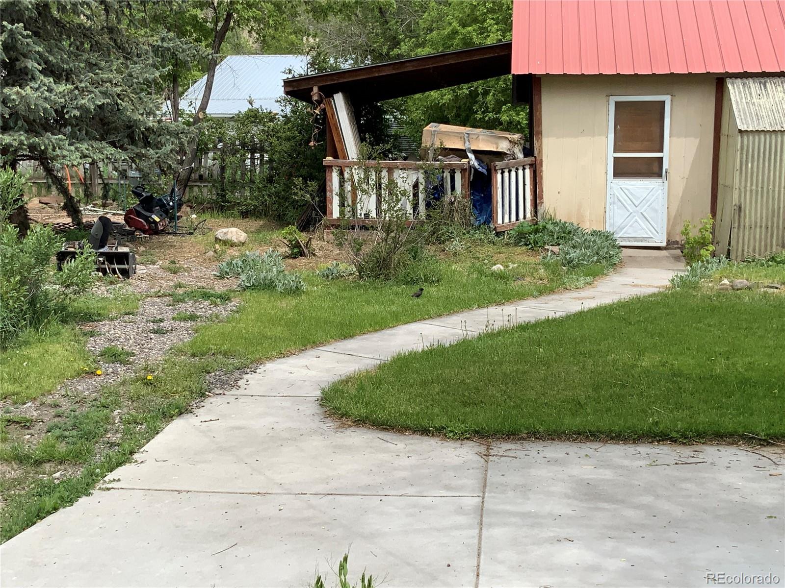 1011 Main Street Meeker, CO 81641 - Photo 13 of 28 a view of a house with backyard and porch