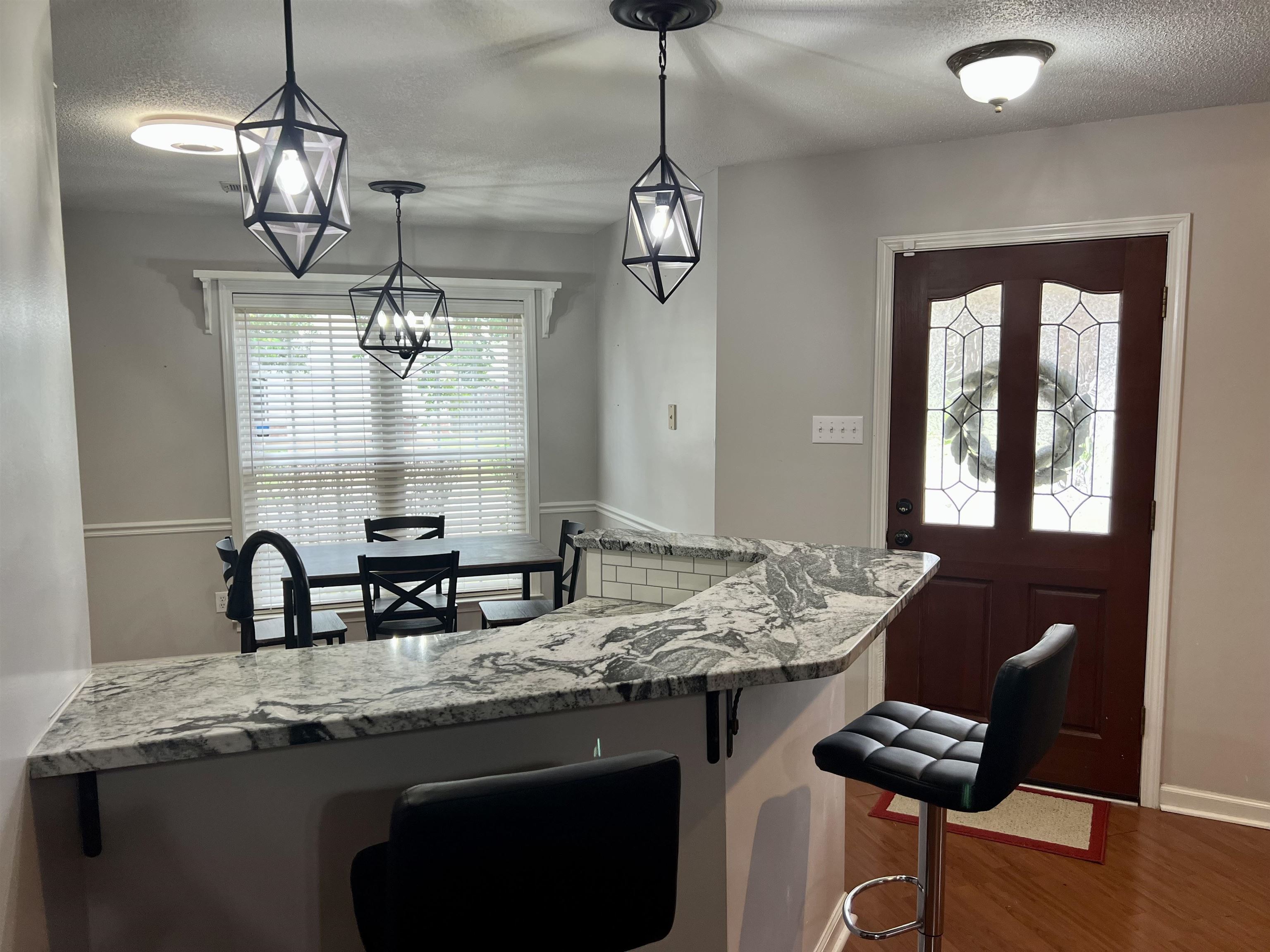 7429 Gingerhill Lane Bartlett, TN 38133 - Photo 4 of 20 a kitchen with granite countertop a stove a sink and chandelier