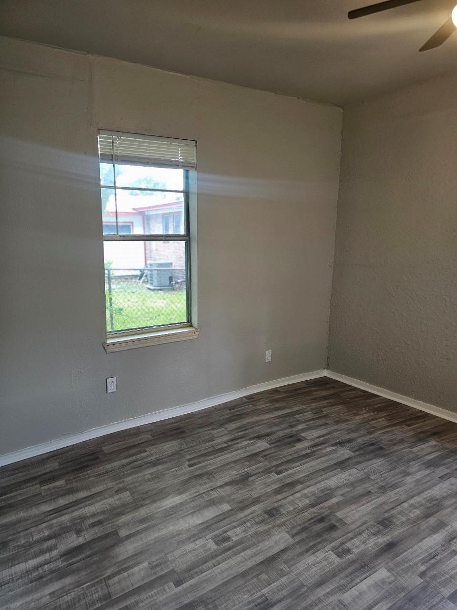 8010 Miley Street Houston, TX 77028 - Photo 7 of 9 a view of an empty room with wooden floor and a window