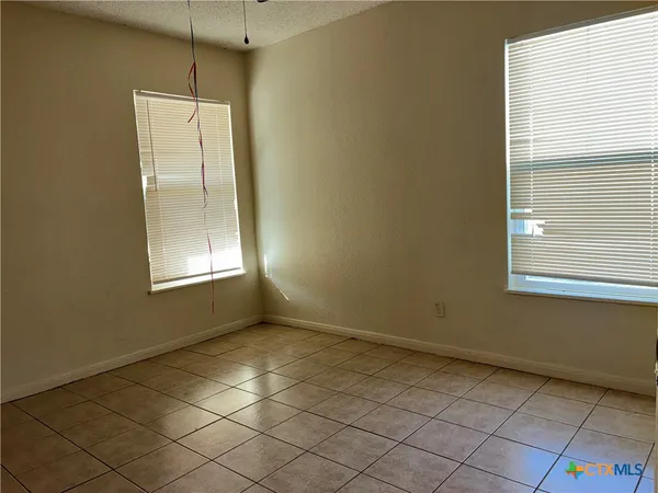 an empty room with windows and closet
