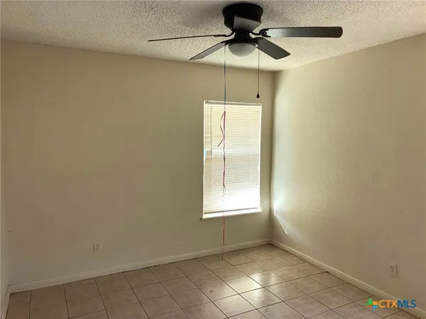 a view of an empty room and a window