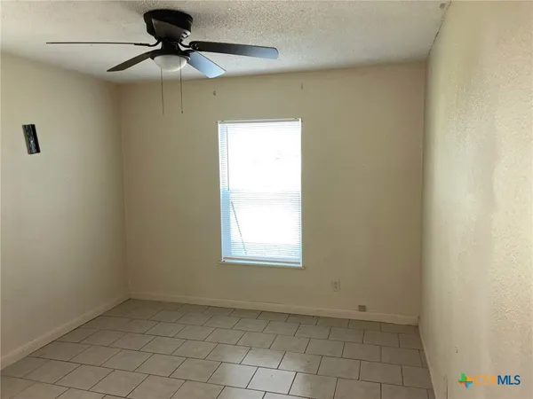 a view of an empty room and window
