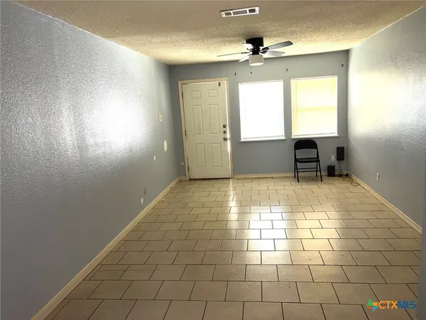 a view of an empty room with a window