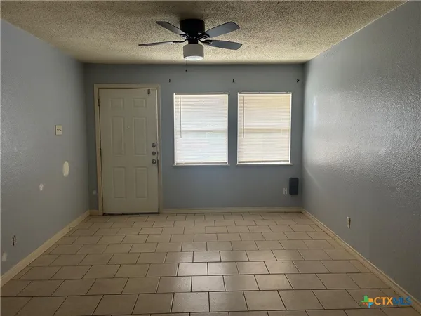 a view of an empty room with a window