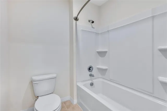 a bathroom with a toilet and bathtub