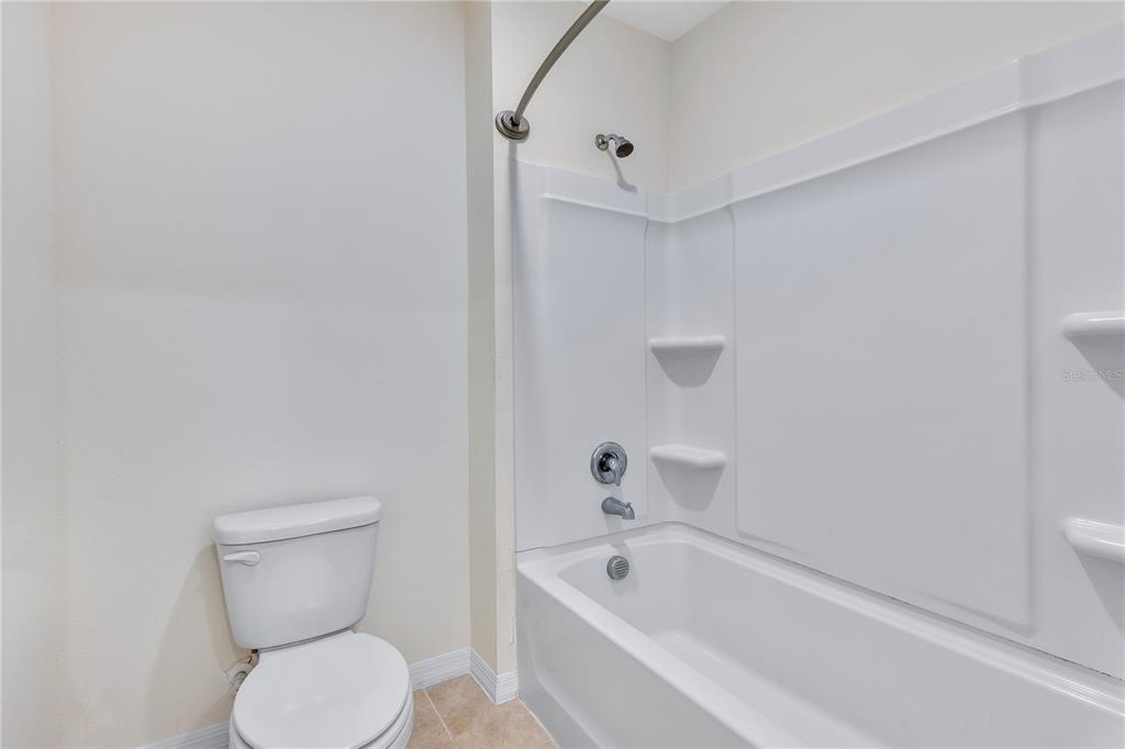 641 Talisi Loop St. Cloud, FL 34771 - Photo 17 of 40 a bathroom with a toilet and bathtub