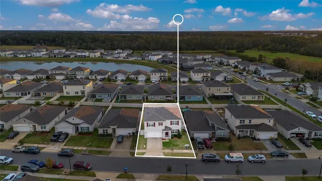 an aerial view of residential houses with outdoor space