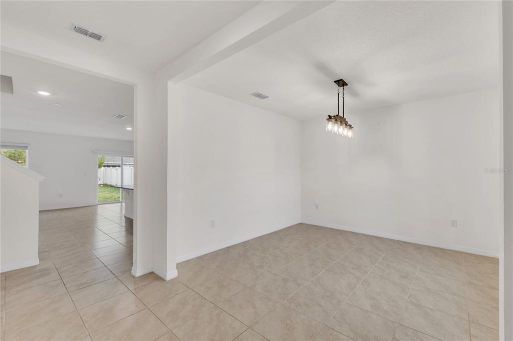 641 Talisi Loop St. Cloud, FL 34771 - Photo 10 of 40 wooden floor in an empty room with a window
