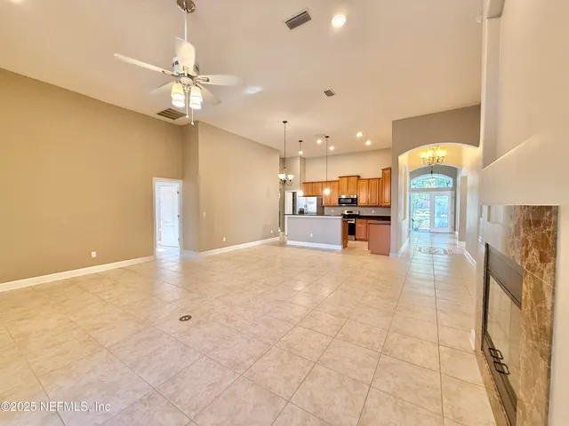 an empty room with closet and a chandelier fan