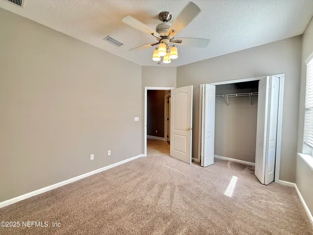 an aerial view of a house with a garden and lake view