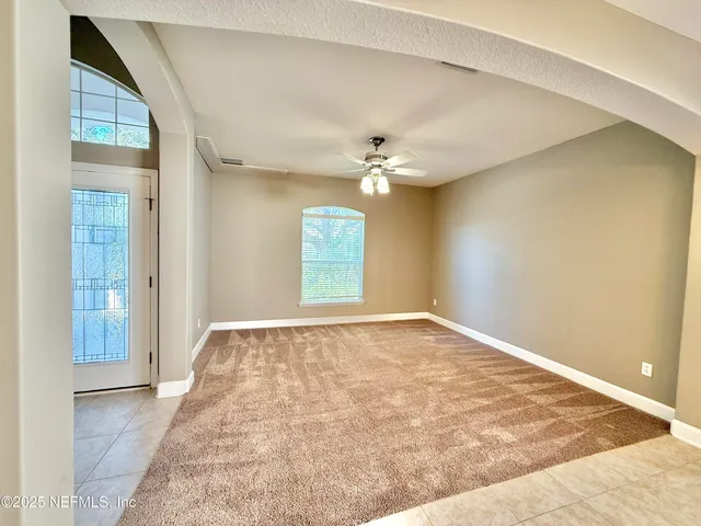 a kitchen with granite countertop a stove a sink and a refrigerator