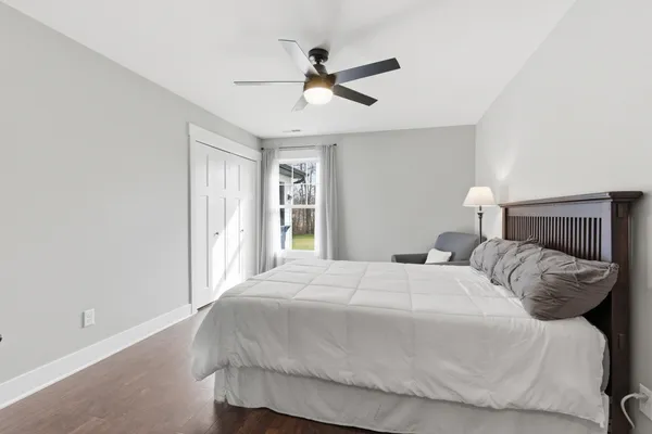 a bedroom with a bed and a large window