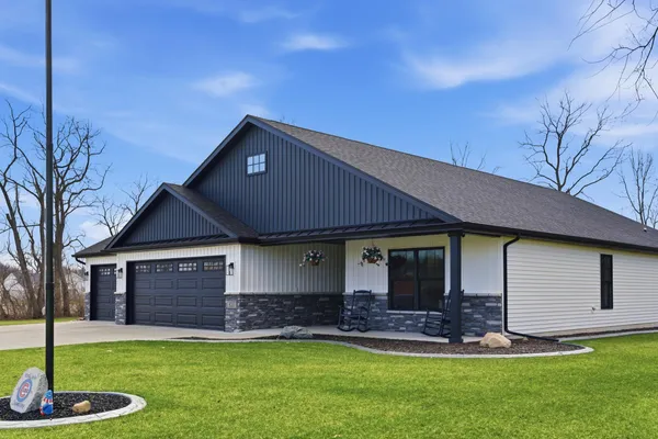 a front view of a house with a yard and garage
