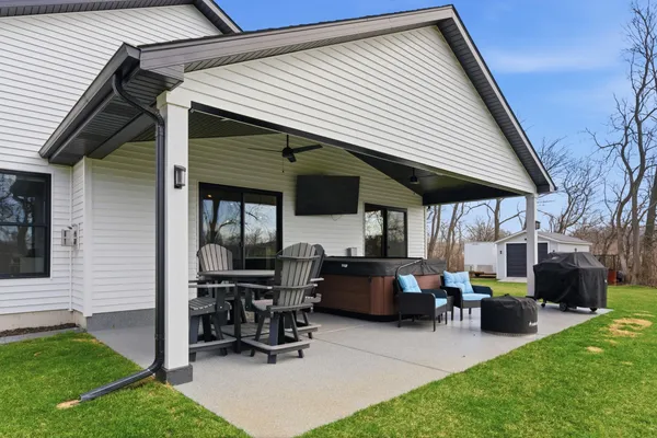 a view of a house with a yard and sitting area
