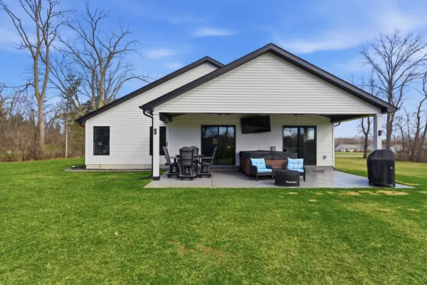 a view of a chair and table in the yard