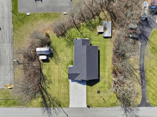 an aerial view of a houses with a lake