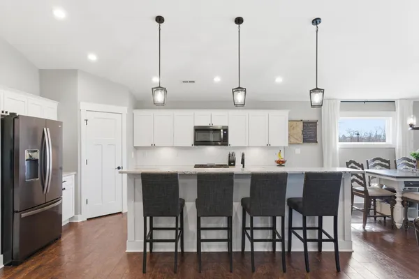 a large kitchen with stainless steel appliances granite countertop a sink and a stove