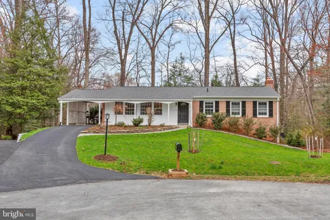a view of deck with furniture and trees
