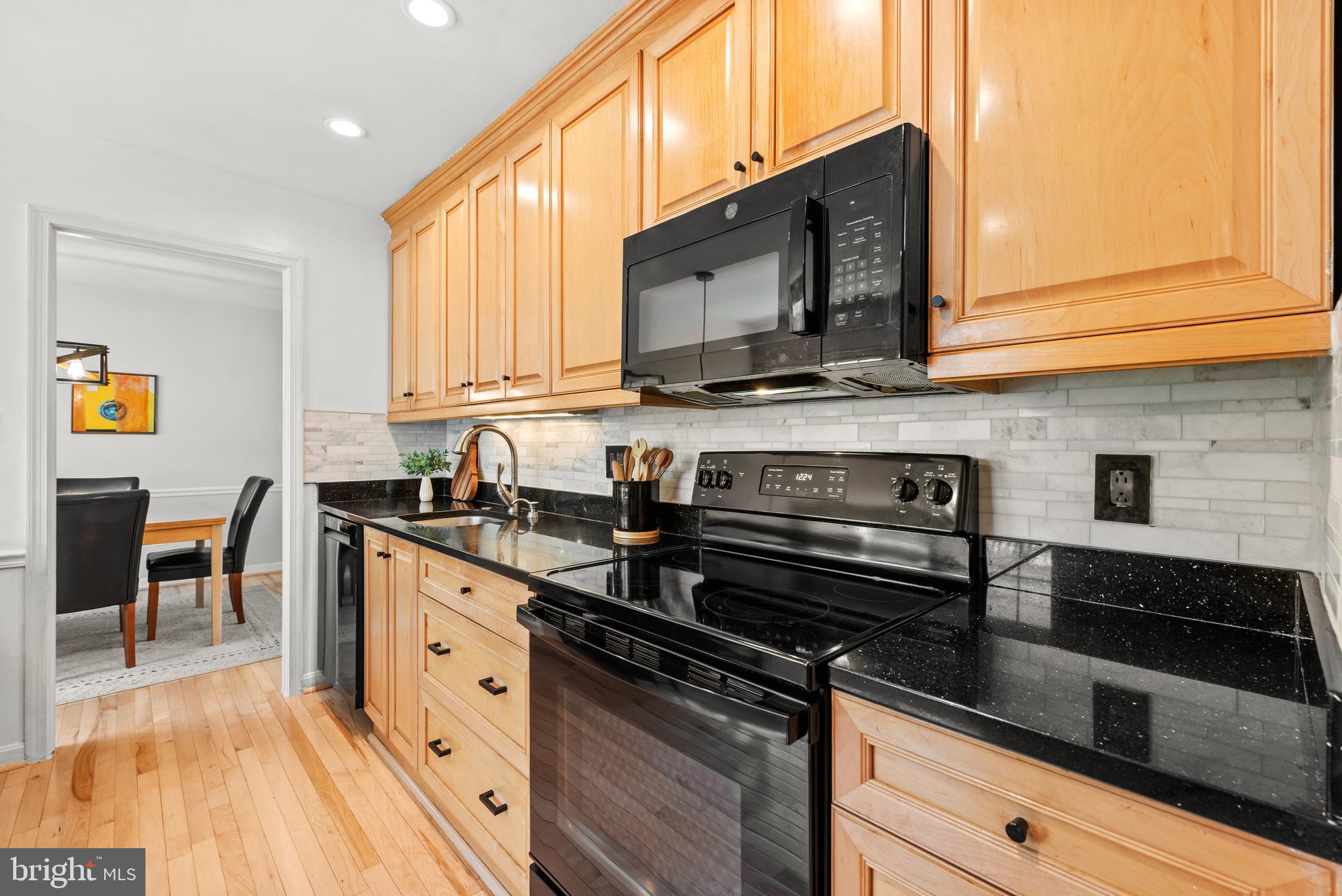 11612 Clipstone Lane Reston, VA 20191 - Photo 11 of 51 a kitchen with stainless steel appliances a stove microwave and cabinets