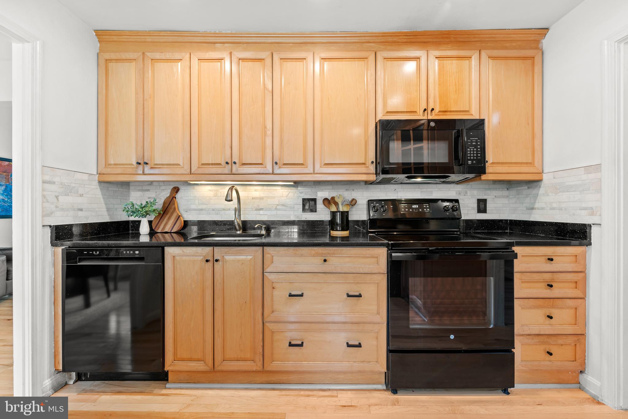 11612 Clipstone Lane Reston, VA 20191 - Photo 13 of 51 a kitchen with stainless steel appliances granite countertop a stove a sink and a microwave