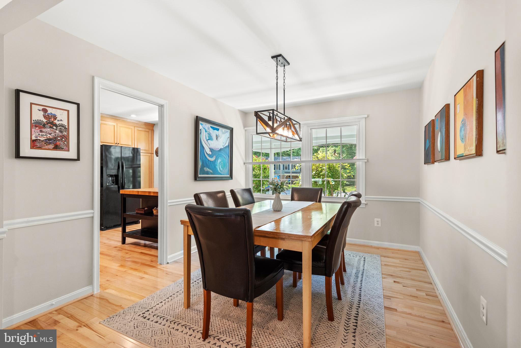 11612 Clipstone Lane Reston, VA 20191 - Photo 10 of 51 a dining room with furniture a chandelier and wooden floor