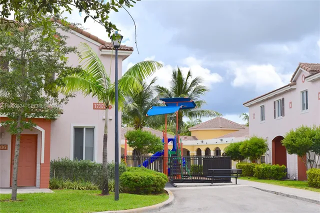 a view of a house with a yard and plants