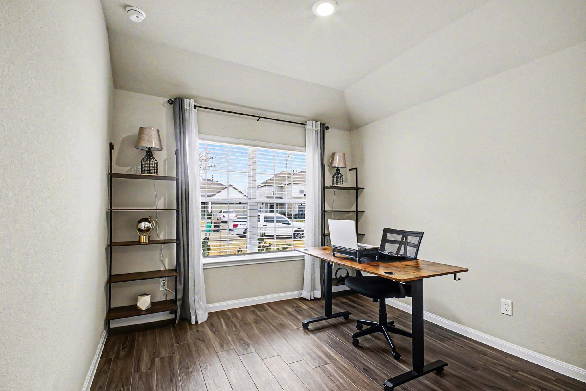 4906 Luke Matthew Drive Rosharon, TX 77583 - Photo 12 of 34 This bright home office features wood flooring, a large window with blinds. It's perfect for a productive workspace.