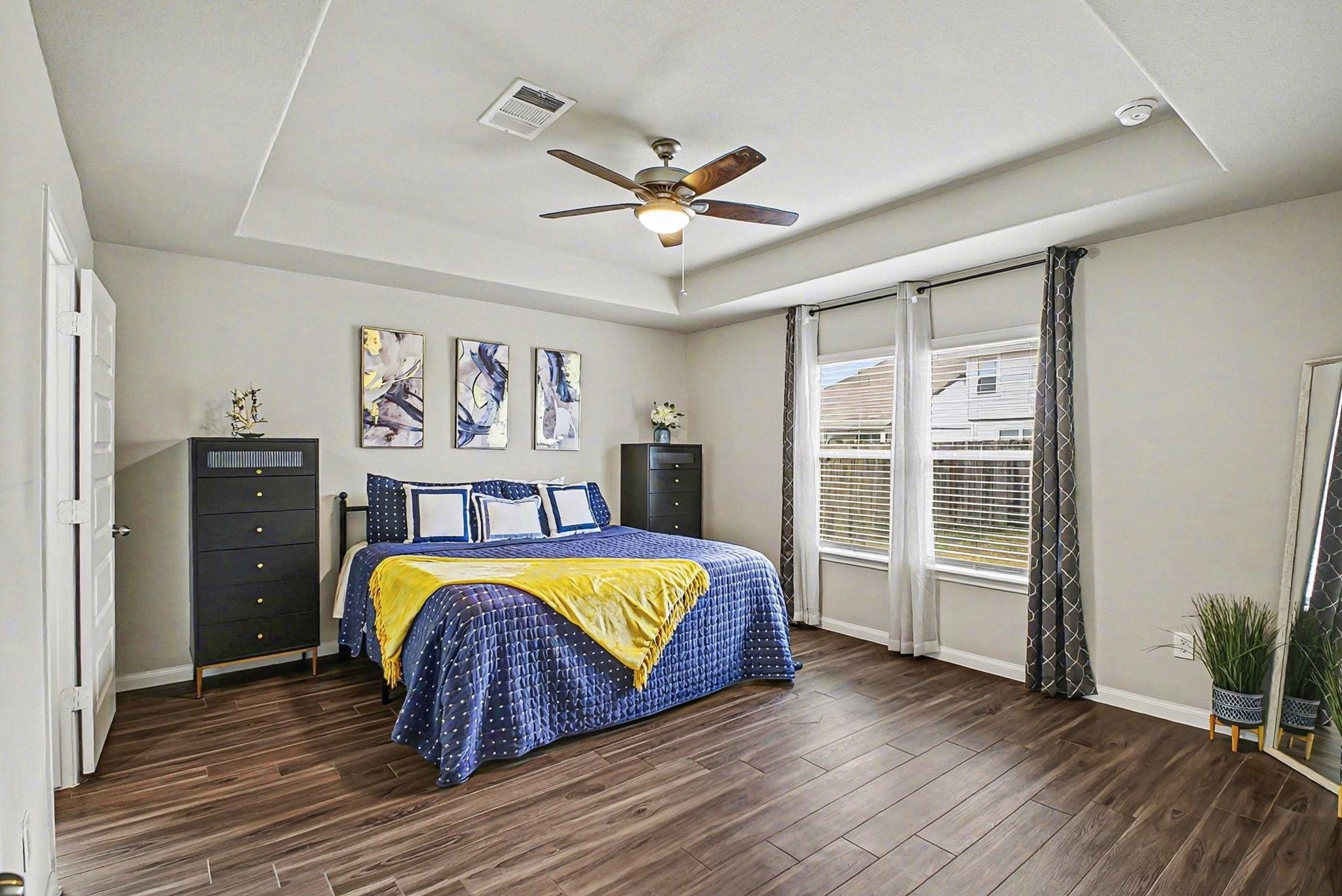4906 Luke Matthew Drive Rosharon, TX 77583 - Photo 14 of 34 Primary bedroom features a modern and spacious design with wood flooring, a ceiling fan, ample natural light and a small open closet with shelving adds to the storage options.