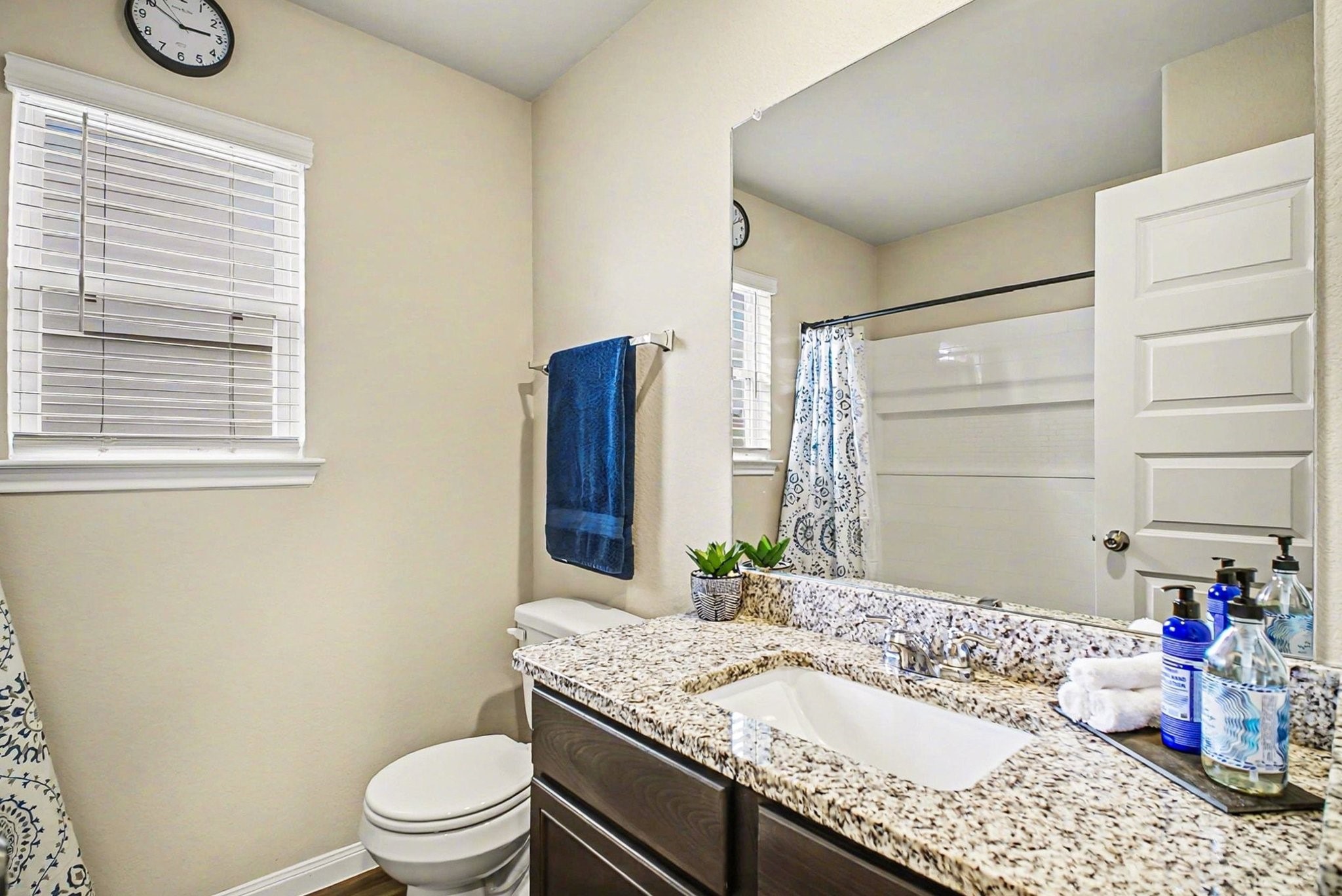 4906 Luke Matthew Drive Rosharon, TX 77583 - Photo 22 of 34 This bathroom features a granite countertop with a modern sink, a large mirror, and a combination shower-tub. Neutral walls and natural light create a bright, inviting space.