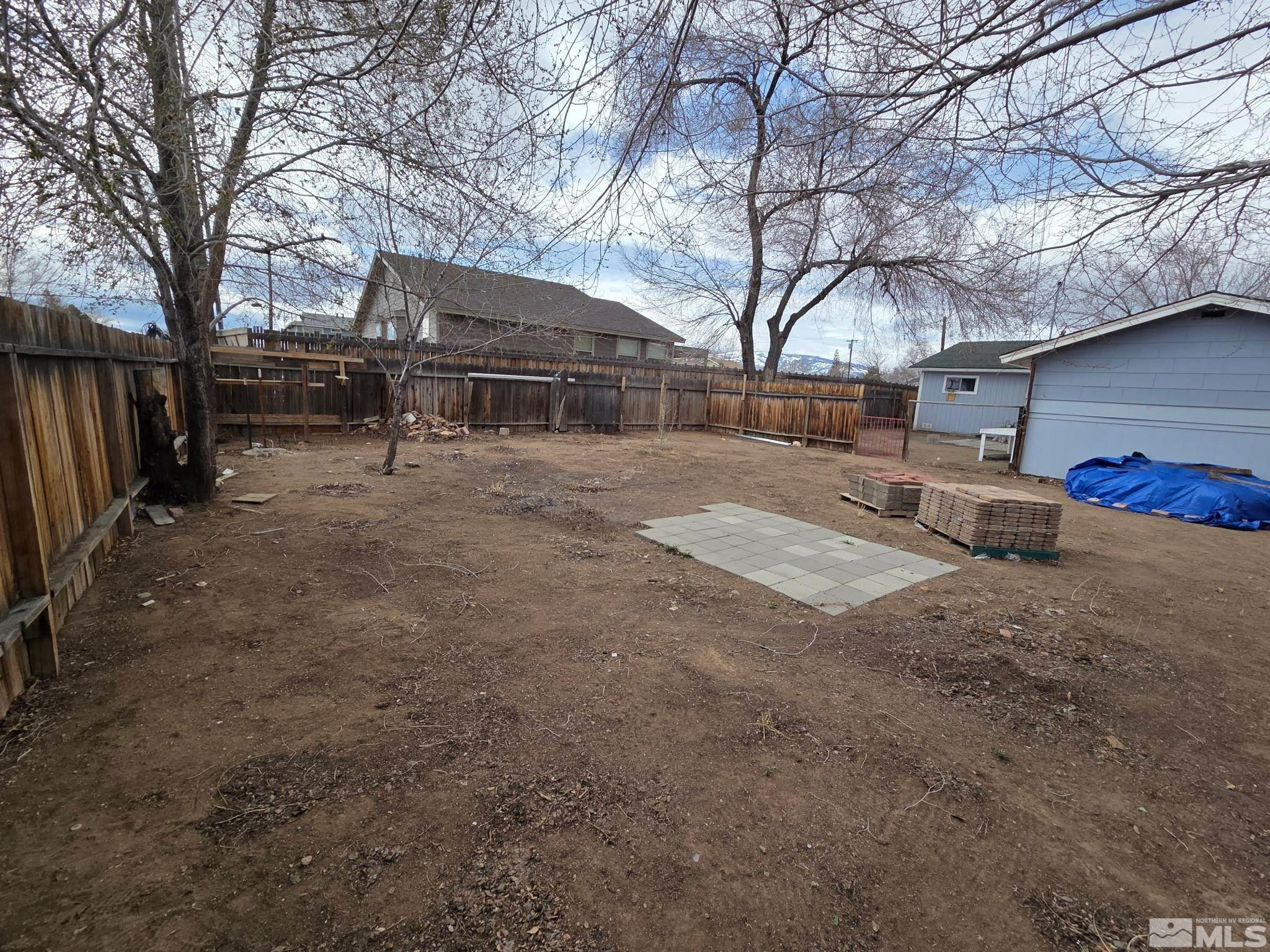 1810 Montello Street Reno, NV 89512 - Photo 16 of 22 a view of backyard with large trees and wooden fence