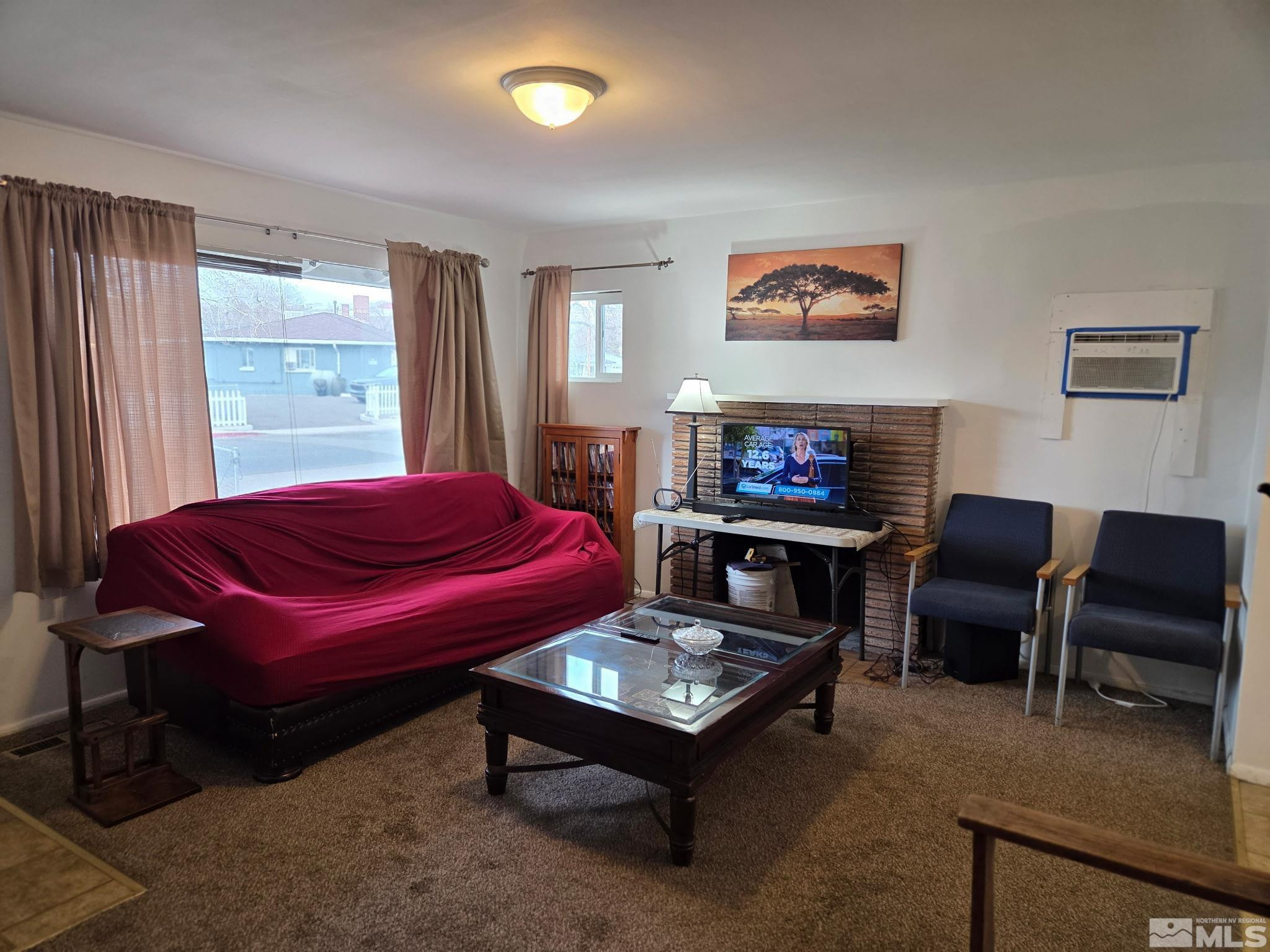 1810 Montello Street Reno, NV 89512 - Photo 4 of 22 a living room with furniture a flat screen tv and a window